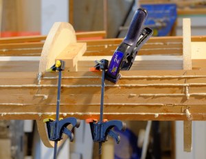 These light weight bar-clamps cost just a few bucks and are ideal for holding strips between stations.